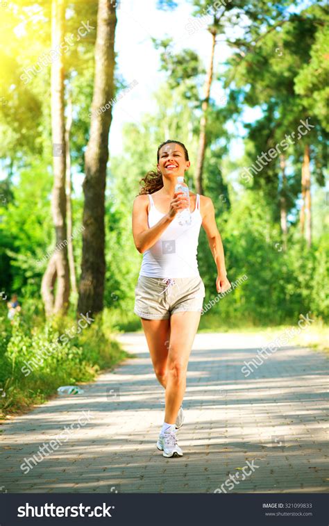 Woman Running In The Park Young Sporty Lady Jogging With