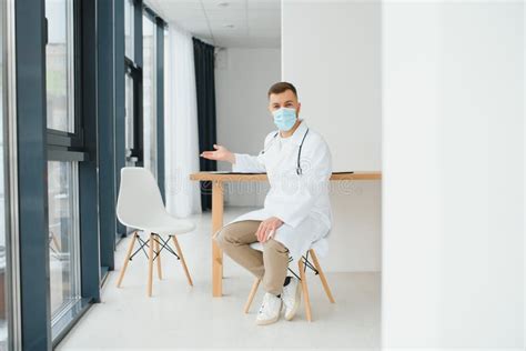 Young Doctor Sitting In His Office Behind A Desk Stock Image Image Of
