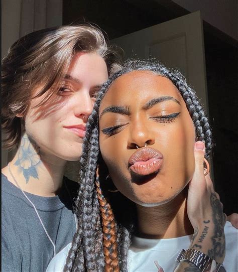 Two Women With Dreadlocks Making Faces And Sticking Their Tongues Out To Each Other