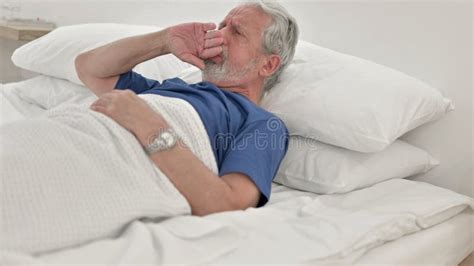 Coughing Sick Senior Old Man Lying In Bed Stock Photo Image Of