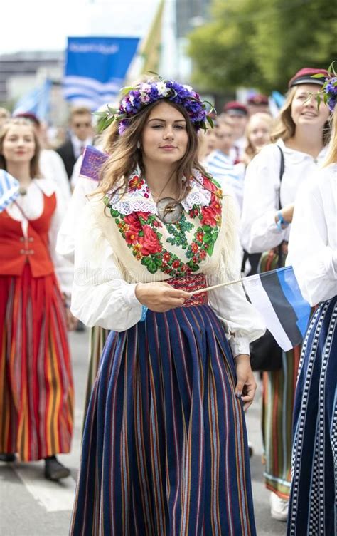 Estonian People In Traditional Clothing Walking The Streets Of Tallinn