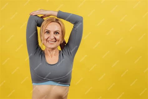 Premium Photo Portrait Of A Smiling Mature Woman Doing Stretching