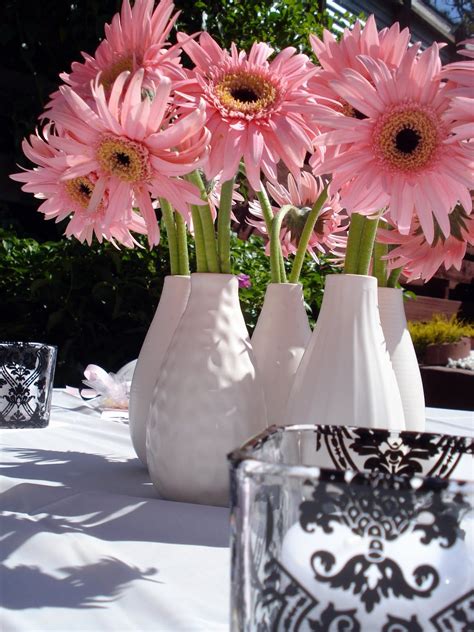0december 4, 2009showered with pink and green. flowers | Girl baby shower decorations, Daisy centerpieces ...