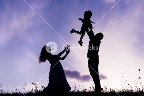 Silhouettes Of Happy Parents Having Fun With Their Children Royalty