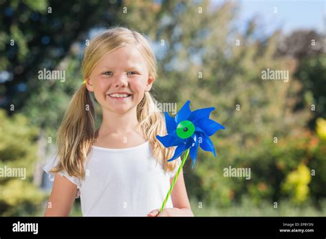 Young Blonde Girl Holding Pinwheel Smiling At Camera Stock Photo Alamy