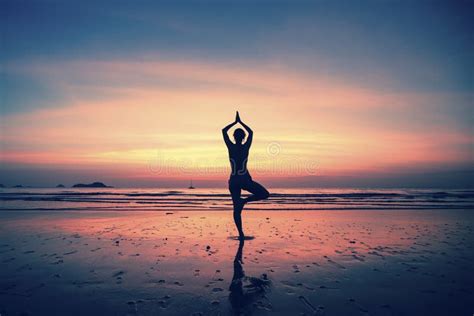 Silhouette Yoga Meditation Girl On The Background Of The Sea And Sunset