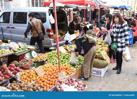 People Selling And Buying In A Traditional Market In The Center Of