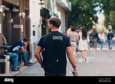 A Man Is Walking Down The Street Stock Photo Alamy