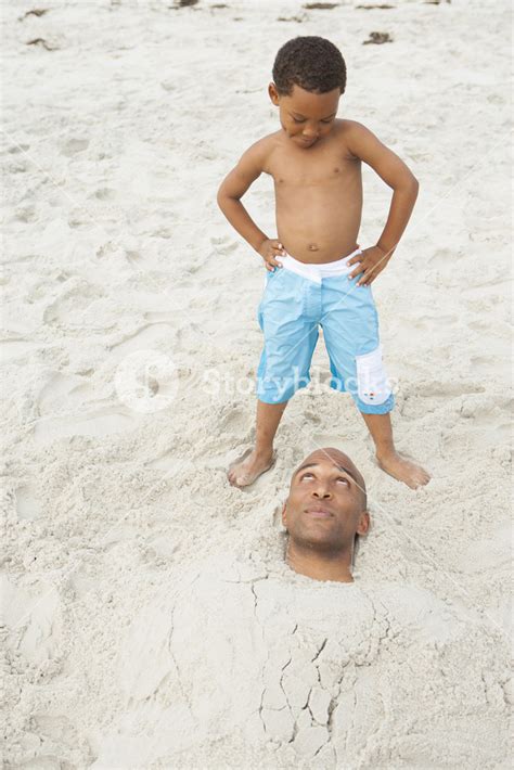 Father Buried In Sand At The Beach Royalty Free Stock Image Storyblocks