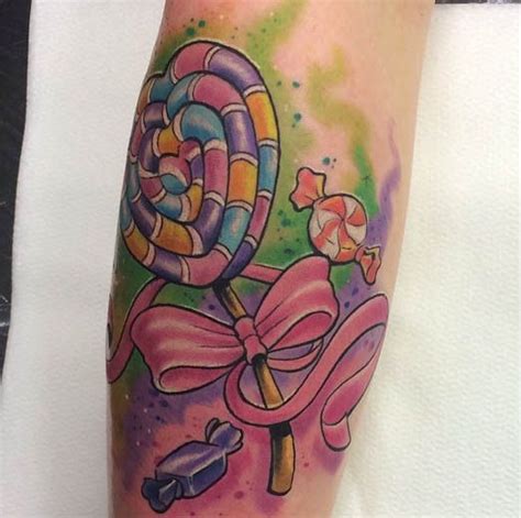 A Colorful Tattoo On The Leg Of A Woman With Candy Canes And Candies