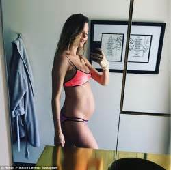 Behati prinsloo and adam levine are expecting baby number two! Pregnant Behati Prinsloo shows off baby bump in tiny ...