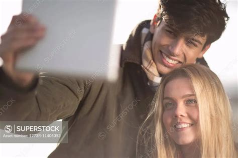 A Young Couple Take Self Portrait Photograph Using Digital Tablet Superstock