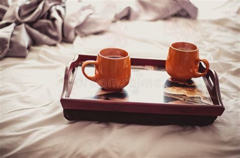 Two Cups Of Hot Drink On A Tray In Bed Morning Breakfast Stock Photo