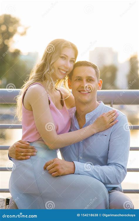 Beautiful Girl Sitting In A Guy S Lap Hugging Him Stock Photo Image