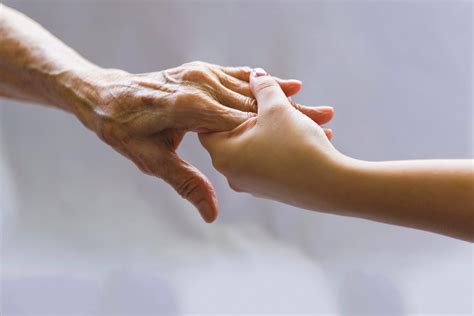 Young Hand Reaching Out To A Elderly Persons Hand Wilson Law Group Llc