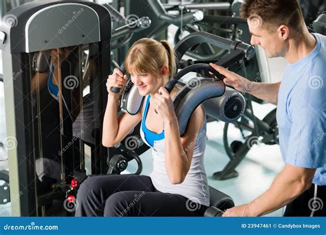 Fitness Center Young Woman Exercise With Trainer Stock Image Image Of