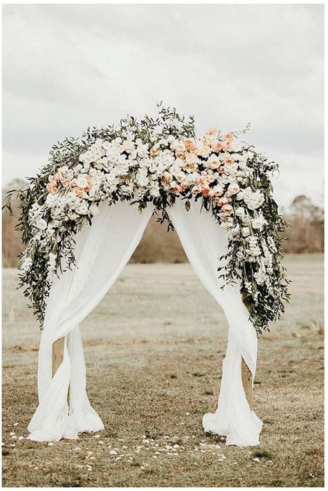 Floral Wedding Arch With White And Peach Flowers Greens And Draped