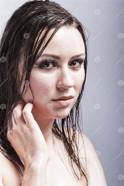 Closeup Portrait Of Caucasian Sensual Brunette Touching Neck And Showing Wet And Shining Skin