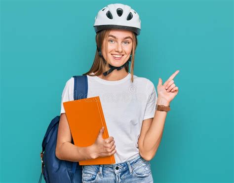 Beautiful Young Blonde Woman Wearing Backpack And Bike Helmet Surprised With An Idea Or Question