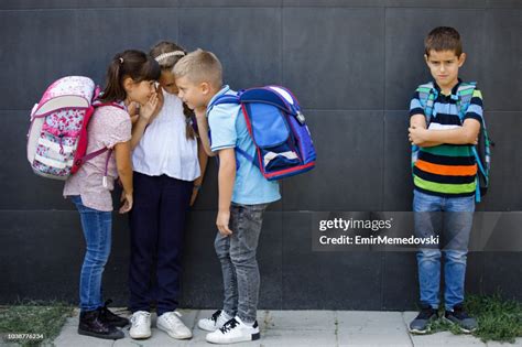 Unhappy Boy Being Gossiped About By School Friends High Res Stock Photo