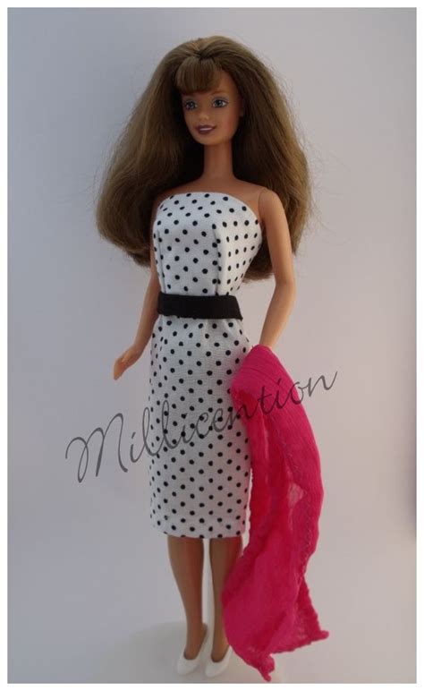 a barbie doll wearing a white and black dress with polka dots