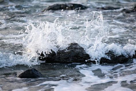 Sea Waves Hitting Rocks On The Beach With Turquoise Sea Water Causing