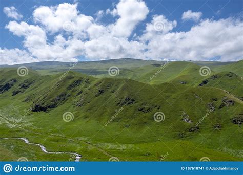 Beautiful Landscape Of Green Mountain Valley With Dramatic Cloudy Sky