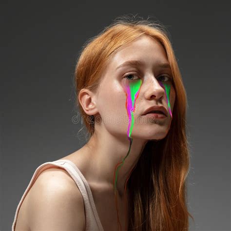 Portrait Of Young Beautiful Woman With Neon Fluid Tears From Eyes