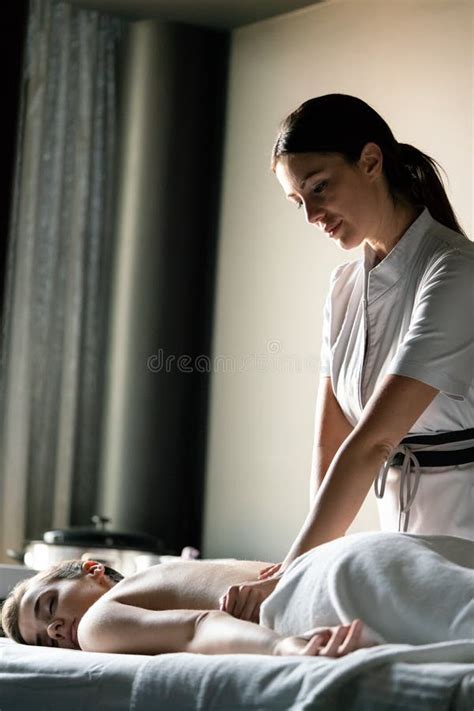 Masseur Doing Massage On Woman Body In The Spa Salon Stock Photo