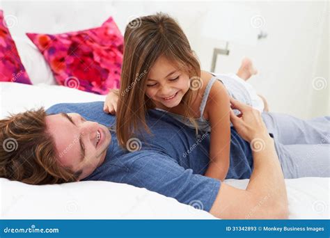 Father And Daughter Lying In Bed Together Stock Image Image Of Waking
