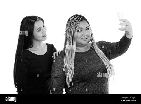 Young Happy Fat Asian Woman And Asian Transgender Woman Smiling While Taking Selfie Picture With
