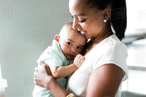 Portrait Of Mother Holding Baby Boy 2 5 Months Stock Photo Dissolve