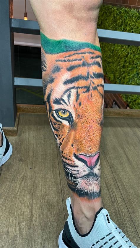 A Man With A Tiger Tattoo On His Leg