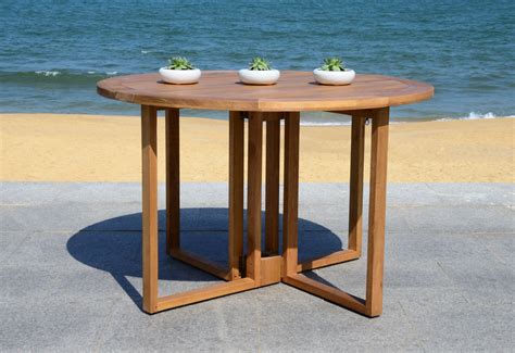 It's also an ideal addition to the family room or for use as an extra workspace. Safavieh Wales Indoor/Outdoor Folding Round Dining Table ...