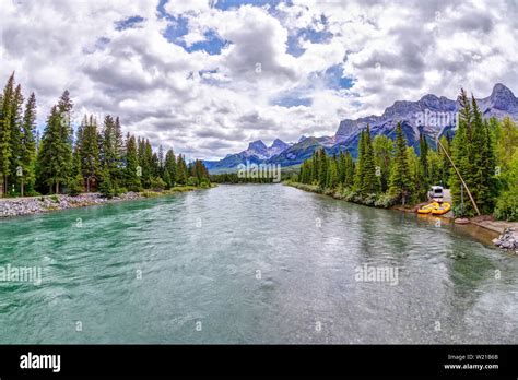 Bow River In Canmore With The Canadian Rockies Mountain Ranges Of The