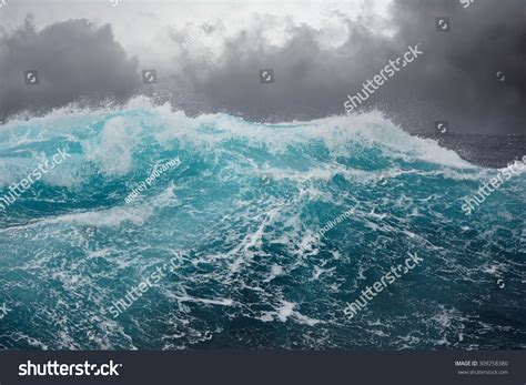 Dark Clouds Crashing Ocean Waves During Stock Photo