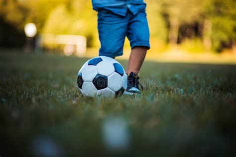 Legs Of Little Boy Playing Football On Grass Stock Photo Image Of