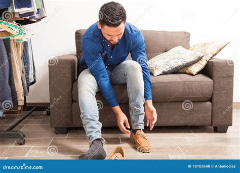 Young Man Putting Shoes On In Dressing Room Stock Photo Image Of