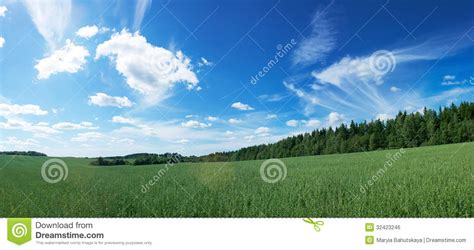 Panoramic Landscape With Green Field And Blue Sky Royalty