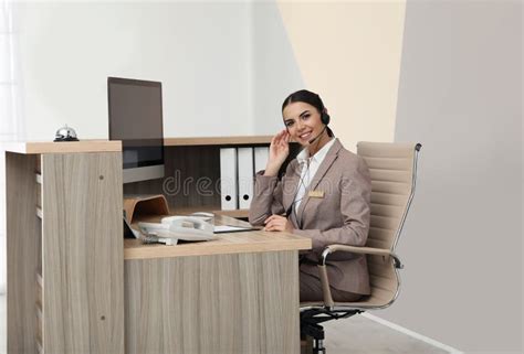 Portrait Of Receptionist Working At Desk Stock Photo Image Of Booking