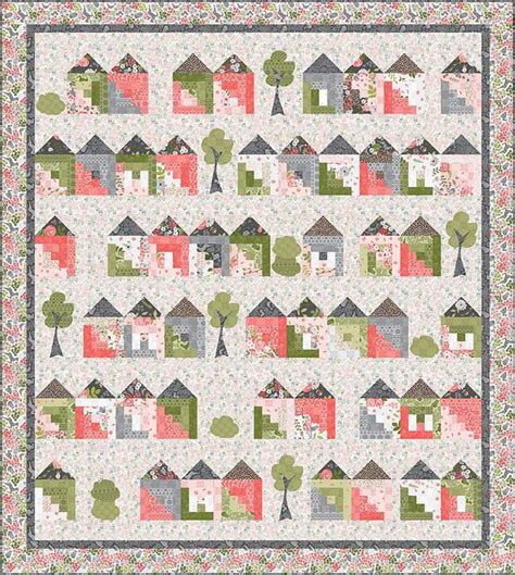 A Quilt With Houses And Trees On It