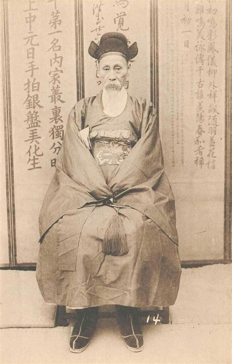 An Old Photo Of A Man Sitting On A Chair