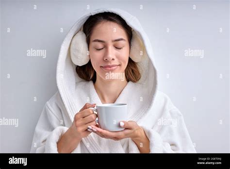 Attractive Young Woman Drinking Tea Or Coffee In The Morning Wearing