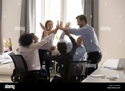 Diverse Multiethnic Colleagues Giving High Five Celebrating Success And