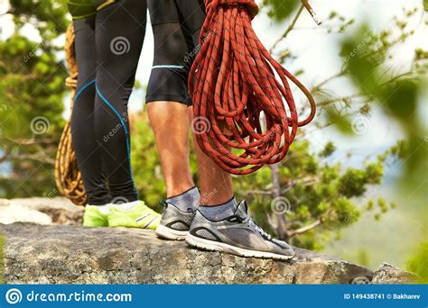 Couple Of Climbers With Ropes On A Cliff Top Mountain Climbing