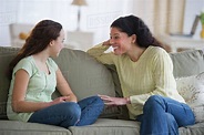 Mother talking to teenage daughter (14-15) - Stock Photo - Dissolve
