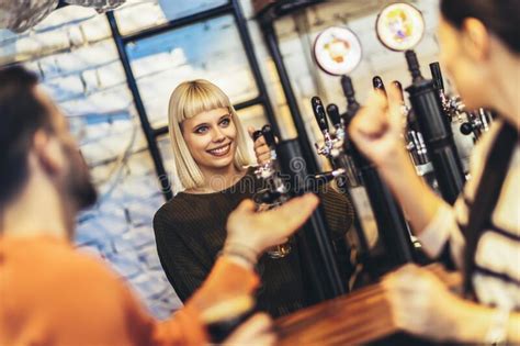 Female Bartender Tapping Beer In Bar Stock Photo Image Of Service