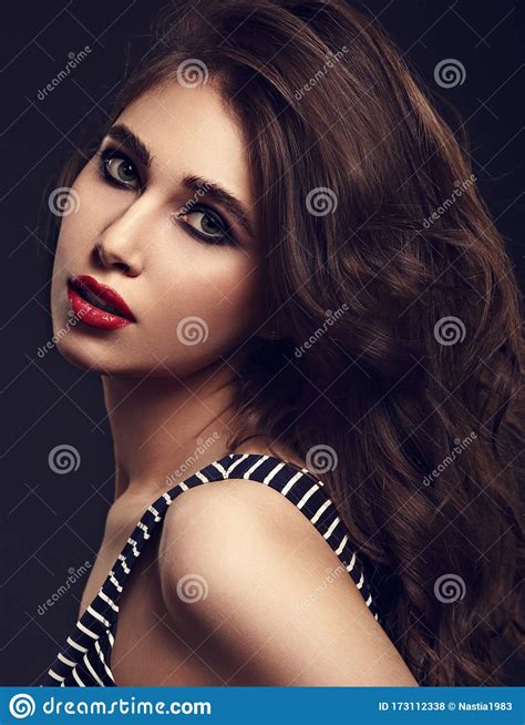Beautiful Bright Makeup Woman With Long Brown Curly Volume Hair Style