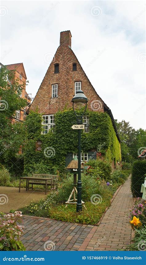 Beautiful Cozy Courtyard With Brick Houses And Plants In The Street Of