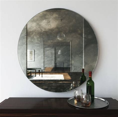 42 antiqued round mirror decorative wall mirror with an interesting cloudy reflection of room